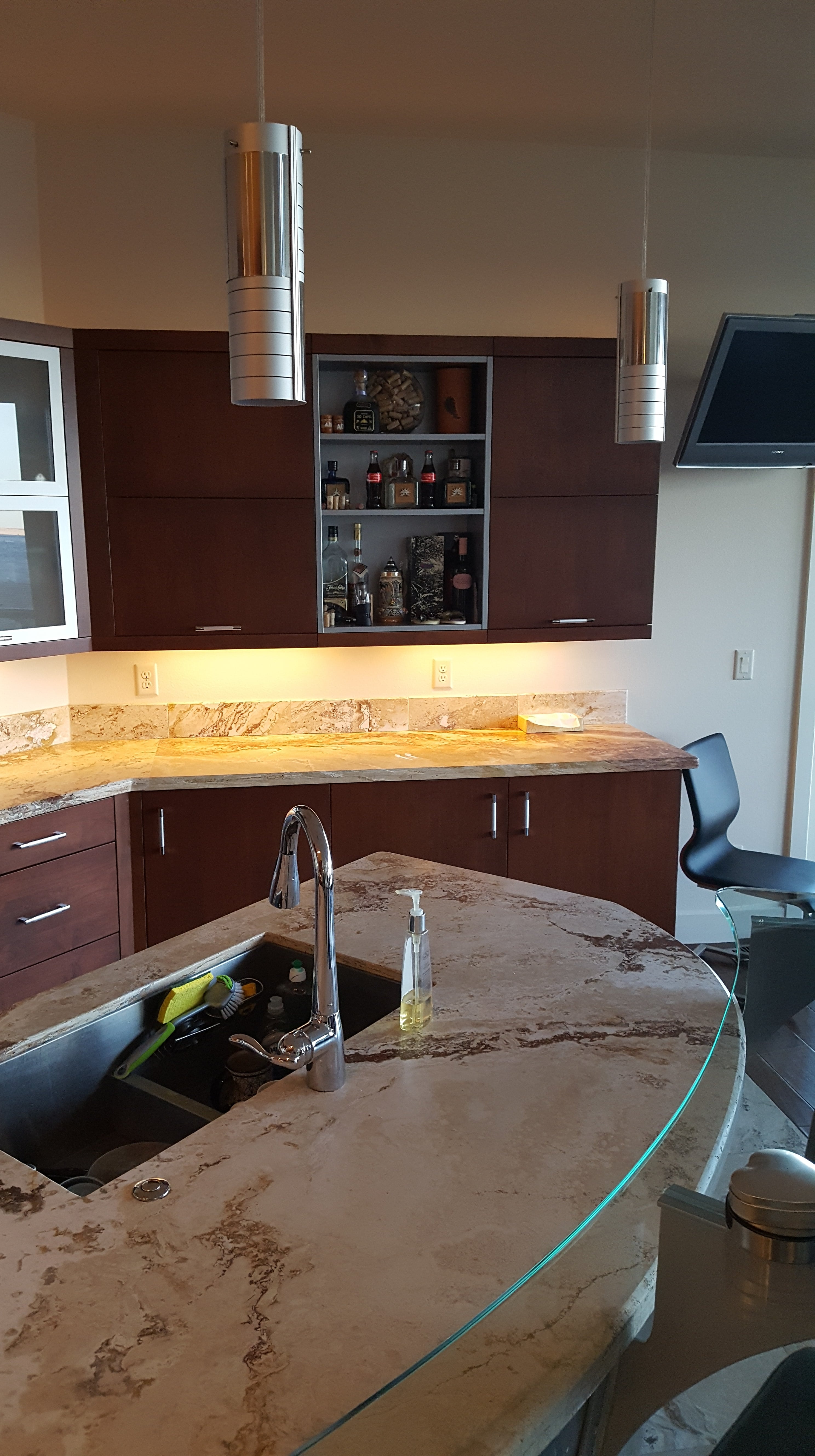 A kitchen with a sink and a counter top