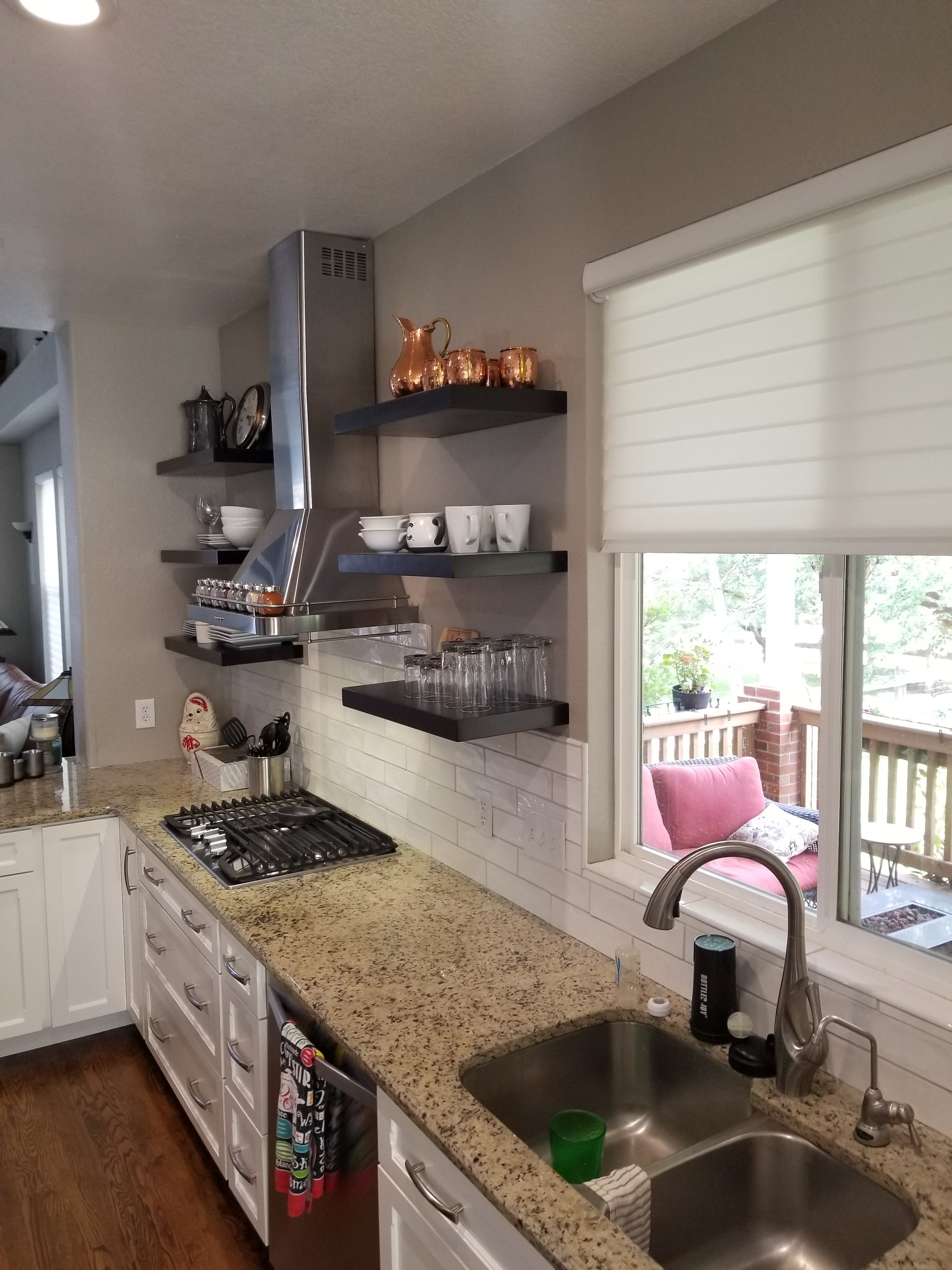 A kitchen with a stove top oven and a sink